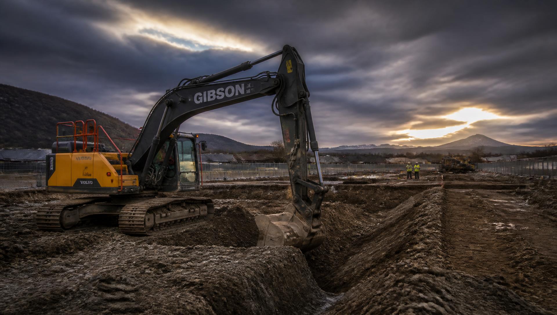 Excavator digging foundation trenches on a construction site